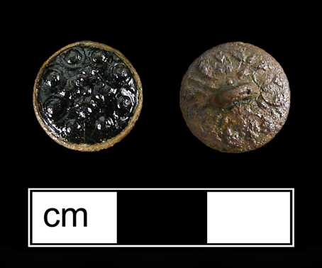This sleeve button has a black glass inset with raised dots on the front.&nbsp;Unlike most examples, this button also has decorative foliate patterns on the back.